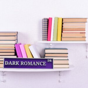Purple Dark Romance Dr bookshelf sign with raised pale lettering, displayed in front of books