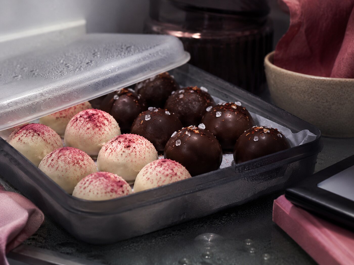 The finished truffles packed into an airtight container in the fridge.